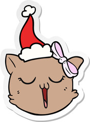 hand drawn sticker cartoon of a cat face wearing santa hat