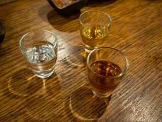 Three small glasses of exotic alcohol in a restaurant