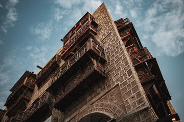 Fototapeta premium Traditional architecture of old Jeddah town El Balad district houses with wooden windows and balconies Unesco Heritage site in Jeddah Saudi Arabia