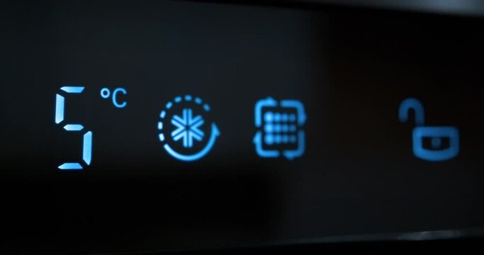 Adjusting temperature of refrigerator on kitchen. Decreasing the temperature on digital LCD display of refrigerator. Reducing temperature from six to zero degrees Celsius. Cinema 4K 60fps video