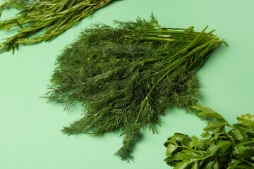 Bunches of fresh parsley, dill and rosemary on color background, closeup