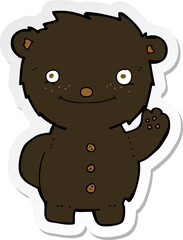 sticker of a cartoon waving black bear
