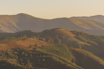 Basque landscape at golden hour during sunset with beautiful hills covered with trees, Aiako Harria, Gipuzkoa, Basque Country, Spain