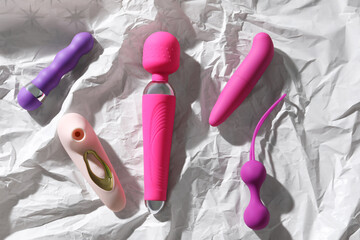 Sex toys on white crumpled paper
