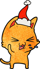 Obraz premium hand drawn textured cartoon of a cat hissing wearing santa hat
