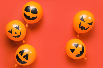 Funny Halloween orange balloons on red background