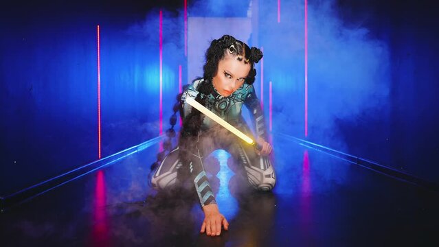 TWoman cyborg robot costume metal body cyberpunk style black braid, fashion model posing beauty face. Sexy alien girl in virtual reality war, lady warrior future vr laser sword in hands. studio smoke