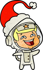 hand drawn textured cartoon of a laughing astronaut wearing santa hat