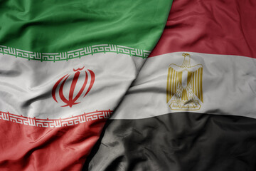big waving realistic national colorful flag of iran and national flag of egypt .