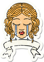 worn old sticker with banner of female face crying