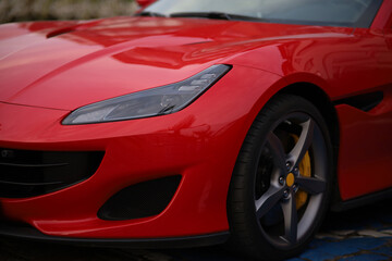 Close-up of a red sports car parked in the street.