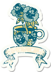 worn old sticker with banner of a cup and flowers