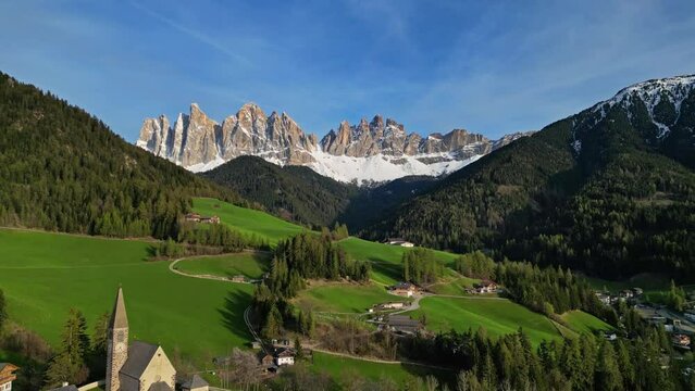 Spring landscape with shurch in Santa Magdalena village, Italian Dolomites Alps, in South Tyrol, Val di Funes, Italy, 4k