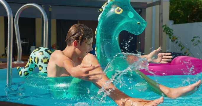 Cute teenager having fun in the pool with an inflatable toy