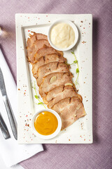 Slices of pork tenderloin with mustard and cress