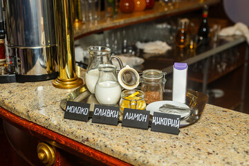 Different types of milk and sour cream on the counter in a restaurant