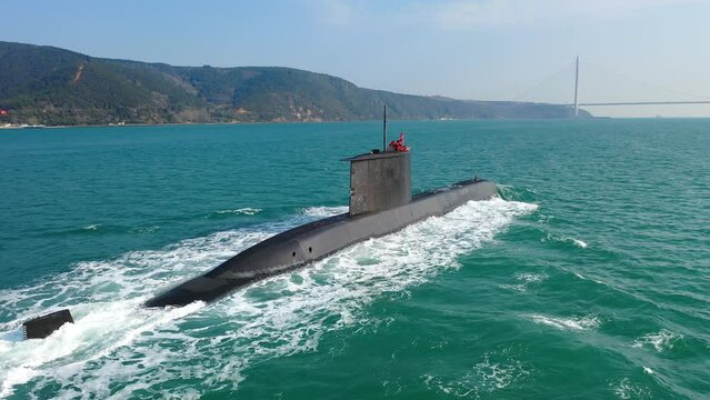 Navy submarine underway on calm waters waving the Turkish flag. Ships of impartial states can pass through Straits while ships of warring states prohibited, Bosphorus, Istanbul