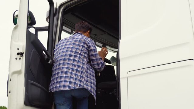 Indian truck driver sits in his truck on parking
