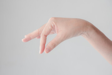 Close up of woman hand picking up something like object isolated on a white background. concept the...