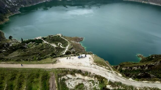 aerial of laguna quilotoa at the quilotoa loop in the andes mountains of Ecuador, is an emerald green lake in a caldera of an old volcano cater and a popular travel destination for hikers.
