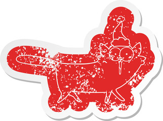 quirky cartoon distressed sticker of a cat wearing santa hat
