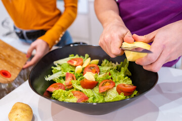 Man cutting ingredients for a salad at home