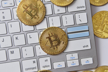 national flag of botswana on the keyboard with bitcoin coins on a grey background.