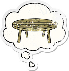 cartoon table with thought bubble as a distressed worn sticker