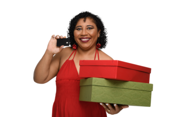 a smiling woman holds a black card with a chip and shopping boxes, she is dressed in red clothes and holds red and green boxes against.