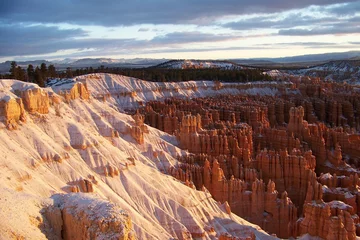 Fotobehang Slopes of Bryce Canyon early in the morning after a snowstorm. Winter sunrise at Bryce Canyon National Park, Utah, USA © Anna