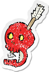 retro distressed sticker of a funny cartoon skull and arrow