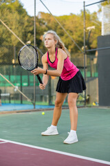 Sports girl is ready to repel an attack while playing tennis