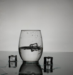 glass of water on the table with ice cubes.