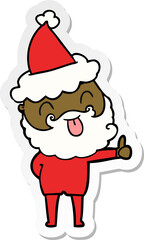 man with beard sticking out tongue wearing santa hat