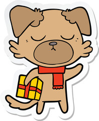 sticker of a cute cartoon dog with christmas present