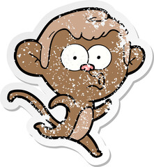 distressed sticker of a cartoon surprised monkey
