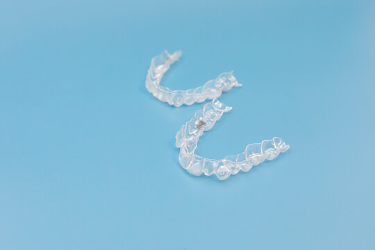 Night mouth guard. Transparent dental aligners for maxillary and mandibular teeth on blue background, Space For Text. Braces, Alignment of teeth. Orthodontic dentistry concept. Dental care. Horizontal