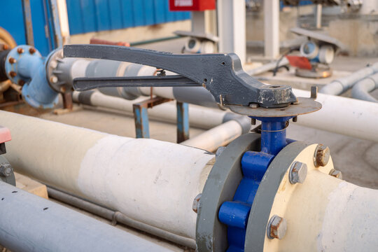 Butterfly manual Valve on the waste water pipe line. The photo is suitable to use for industry background photography, power plant poster and electricity content media.