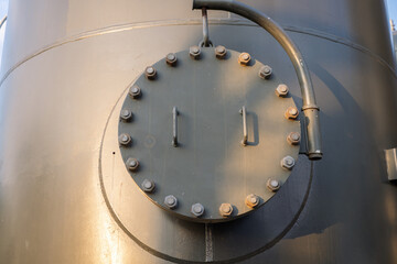 Man hole of tank and bona pipe on the power plant project. The photo is suitable to use for industry background photography, power plant poster and electricity content media.