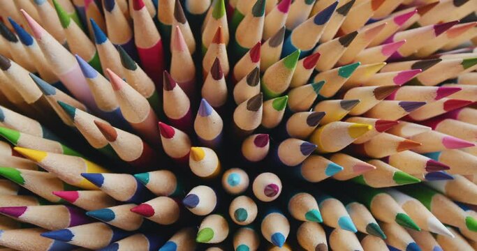 Background of colored pencils rotating in a circle on a black background.