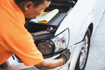 Skilled technician make refurbishment of bodywork in automotive car service, replacing or...