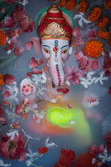 Close-up of Eco-friendly Ganpati Visarjan ceremony at home. Top view.