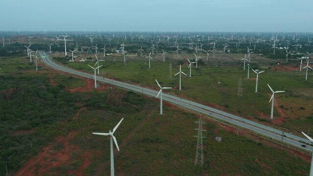 Beautiful view of Windmills or Wind Turbines farm in Nagercoil, South India_ and highwayroad moving shot