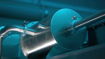 Close up of metal equipment at the factory. Stock footage. Metal tube and container.