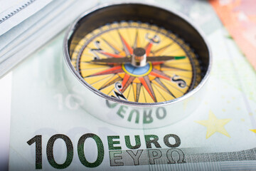 Compass and Euro banknotes as business, currency finance  concept