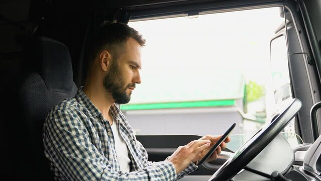 Professional trucker using truck gps navigation to transport and deliver goods to the destination