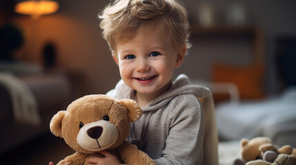 A cute little boy looks at the camera, smiles and play with toys