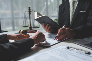 Consulting of business woman and male lawyer or legal consultant having team meeting with client,...