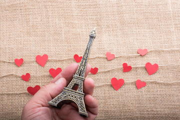  Love concept with Eiffel tower in hand and heart