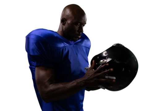 Digital png photo of african american rugby player holding helmet on transparent background